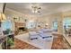 Bright living room with a brick fireplace, comfortable seating, hardwood floors, and natural light at 394 Runnymede Dr, Rock Hill, SC 29732