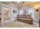 Relaxing living room with a leather reclining sofa, neutral tones, and ample natural light at 394 Runnymede Dr, Rock Hill, SC 29732