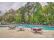 Community pool area with lounge chairs and tables for relaxation at 394 Runnymede Dr, Rock Hill, SC 29732