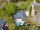 An aerial view of the home showcases the backyard pool, mature landscaping and architectural roof design at 4721 Myers Ln, Harrisburg, NC 28075