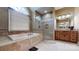 A luxurious bathroom with tiled floors, a soaking tub, a glass shower, and double vanity at 4721 Myers Ln, Harrisburg, NC 28075