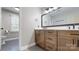 Modern bathroom with wooden cabinets, sleek countertops, and matte black fixtures at 4721 Myers Ln, Harrisburg, NC 28075