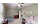 Cozy bedroom adorned with personalized decor, a ceiling fan, and warm neutral colors at 4721 Myers Ln, Harrisburg, NC 28075