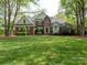 Beautiful brick home with a manicured lawn, mature trees, and a welcoming entrance at 4721 Myers Ln, Harrisburg, NC 28075