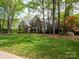 Charming brick home with lush landscaping, mature trees, and a well-maintained lawn at 4721 Myers Ln, Harrisburg, NC 28075