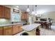A spacious kitchen featuring a center island, wood cabinets, and tile backsplash at 4721 Myers Ln, Harrisburg, NC 28075