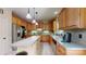 A modern kitchen with stainless appliances, light wood cabinets, an island, and neutral countertops at 4721 Myers Ln, Harrisburg, NC 28075