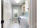 Practical laundry room with modern washer and dryer, and ample cabinet storage at 4721 Myers Ln, Harrisburg, NC 28075