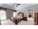 Comfortable main bedroom featuring a tray ceiling, neutral decor, and a walk-in closet at 4721 Myers Ln, Harrisburg, NC 28075