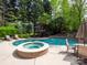 Backyard with a swimming pool, hot tub, patio with furniture, and manicured landscaping at 4721 Myers Ln, Harrisburg, NC 28075