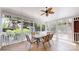 Charming screened porch with wood floors and ceiling fan, perfect for enjoying the outdoors at 4721 Myers Ln, Harrisburg, NC 28075