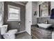 Modern bathroom with a vessel sink, sleek vanity, toilet, shiplap wall, and tasteful fixtures at 501 8Th Sw Ave, Conover, NC 28613