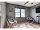 Bedroom featuring two chairs, hardwood floors, a ceiling fan, natural light, and neutral walls at 501 8Th Sw Ave, Conover, NC 28613