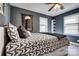 Comfortable bedroom with stylish bedding, multiple windows, and ample natural light with shelving nearby at 501 8Th Sw Ave, Conover, NC 28613