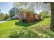 Side view of brick home highlighting landscaping and mature trees at 501 8Th Sw Ave, Conover, NC 28613