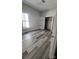 Well-lit bedroom featuring modern wood-look flooring and ample closet space at 510 S Yadkin Ave, Spencer, NC 28159