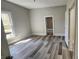 Spacious bedroom with neutral walls, wood-look floors, and large window allowing ample natural light at 510 S Yadkin Ave, Spencer, NC 28159