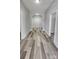 Inviting hallway featuring elegant archway, white trim and moldings, and modern wood-look flooring at 510 S Yadkin Ave, Spencer, NC 28159