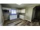 Modern kitchen featuring granite counters, white cabinetry, and stainless steel microwave at 510 S Yadkin Ave, Spencer, NC 28159