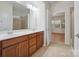 Bright bathroom featuring double vanity, tile floors, and a shower with glass doors at 527 Livingston Dr, Lancaster, SC 29720