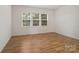 Bedroom featuring hardwood floors and bright natural light from a multi-pane window at 527 Livingston Dr, Lancaster, SC 29720