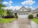Inviting single-story home with a well-manicured lawn, mature shrubs, and an attached two-car garage at 527 Livingston Dr, Lancaster, SC 29720