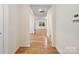 Hallway with hardwood floors and bright white walls offers views into other rooms at 527 Livingston Dr, Lancaster, SC 29720