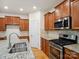 Kitchen with granite countertops, stainless steel appliances, and wooden cabinetry at 527 Livingston Dr, Lancaster, SC 29720