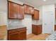 Kitchen with stone counter tops and backsplash along with brown cabinets at 527 Livingston Dr, Lancaster, SC 29720