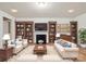 Cozy living room featuring a fireplace, hardwood floors, bookshelves, and comfortable seating at 527 Livingston Dr, Lancaster, SC 29720