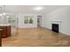 Open living space with fireplace, hardwood floors and lots of light with windows and glass door at 527 Livingston Dr, Lancaster, SC 29720