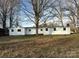 Rear exterior of a white home with a dark roof and bare trees surrounding the property at 539 Jennings Rd, Statesville, NC 28625