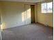 Bright bedroom with neutral carpet, closet, and large window offering natural light at 539 Jennings Rd, Statesville, NC 28625