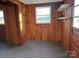 Cozy entryway features knotty pine walls, tiled floors, shelving, and natural light at 539 Jennings Rd, Statesville, NC 28625