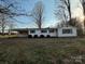 Charming one-story home with a covered parking, green shutters, and manicured bushes at 539 Jennings Rd, Statesville, NC 28625