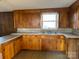 Traditional kitchen featuring wood cabinets, laminate countertops, and a stainless steel sink at 539 Jennings Rd, Statesville, NC 28625