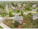 Aerial view of a property with mature trees, lush landscaping, and neighborhood streets at 5629 Berry Ridge Dr, Harrisburg, NC 28075