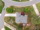 Stunning aerial view of property featuring lush landscaping and a cozy backyard fire pit at 5629 Berry Ridge Dr, Harrisburg, NC 28075