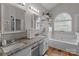 Bright bathroom boasts double vanity, granite countertops, and soaking tub at 5629 Berry Ridge Dr, Harrisburg, NC 28075