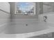 Well-lit bathroom features a soaking tub and natural lighting at 5629 Berry Ridge Dr, Harrisburg, NC 28075