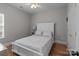 Bright primary bedroom featuring wood floors, a ceiling fan, and a large window at 5629 Berry Ridge Dr, Harrisburg, NC 28075