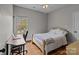 Bedroom featuring a desk, wood floors, and a large window at 5629 Berry Ridge Dr, Harrisburg, NC 28075