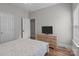 Bedroom featuring wood floors, a ceiling fan, and a large window at 5629 Berry Ridge Dr, Harrisburg, NC 28075
