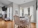 Inviting dining area with white chairs and round table, adjacent to a cozy living space with a fireplace at 5629 Berry Ridge Dr, Harrisburg, NC 28075