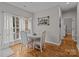 Bright dining area features a modern light fixture, decor and large windows covered with sheer curtains at 5629 Berry Ridge Dr, Harrisburg, NC 28075