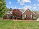 Charming brick home with a well-kept lawn, beautiful landscaping, and a inviting walkway at 5629 Berry Ridge Dr, Harrisburg, NC 28075