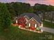 Beautiful brick home with a well-manicured lawn, a side-entry garage, and mature trees at 5629 Berry Ridge Dr, Harrisburg, NC 28075