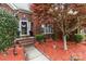 Charming brick home with a well-kept lawn, walkway, and beautiful landscaping at 5629 Berry Ridge Dr, Harrisburg, NC 28075