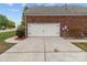 A two car garage with a wide concrete driveway offers plenty of parking at 5629 Berry Ridge Dr, Harrisburg, NC 28075