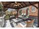 Outdoor deck with a gazebo, hot tub, and comfortable seating at 5629 Berry Ridge Dr, Harrisburg, NC 28075